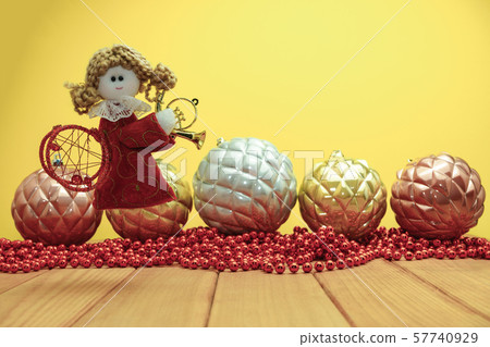 Beautiful Christmas bauble angel toy on a red Beautiful Christmas bauble angel toy on a red 57740929