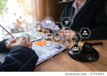 Legal counsel presents to the client a signed contract with gavel and legal law. justice and lawyer concept in office. 57741665