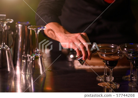 Closeup bartender hand preparing fresh juice Closeup bartender hand preparing fresh juice 57744208