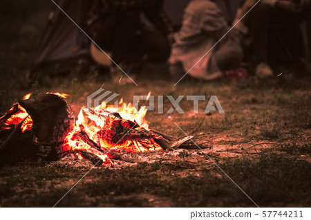 Sparking bonfire with tourist people sit around Sparking bonfire with tourist people sit around 57744211