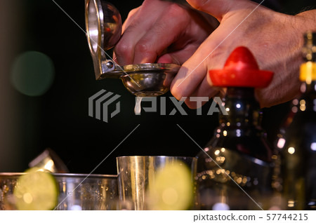 Closeup bartender hand preparing fresh juice Closeup bartender hand preparing fresh juice 57744215