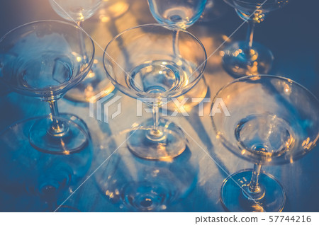 Row of wineglasses on table in nightclub bar and Row of wineglasses on table in nightclub bar and 57744216
