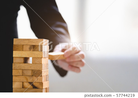 Businessman take and picking one wood block on Businessman take and picking one wood block on 57744219