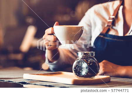 Closeup of professional female barista hand making Closeup of professional female barista hand making 57744771