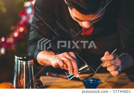 Professional bartender preparing fresh juice Professional bartender preparing fresh juice 57744801