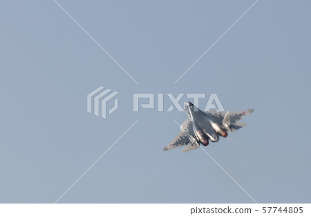 A military fighter jet flying in the gray sky A military fighter jet flying in the gray sky 57744805
