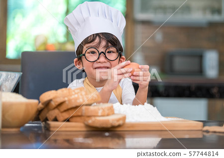 Portrait cute little Asian happy boy interested in Portrait cute little Asian happy boy interested in 57744814