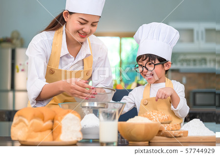 Cute little Asian boy and beautiful mother sifting 57744929