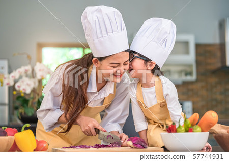 Happy cute little boy with eyeglasses kissing 57744931