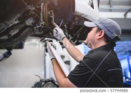 Asian male car technician car maintenance for 57744986