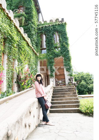 A Japanese woman walks through the castle in the forest. The woman wore a hat. A Japanese woman walks through the castle in the forest. The woman wore a hat. 57745116
