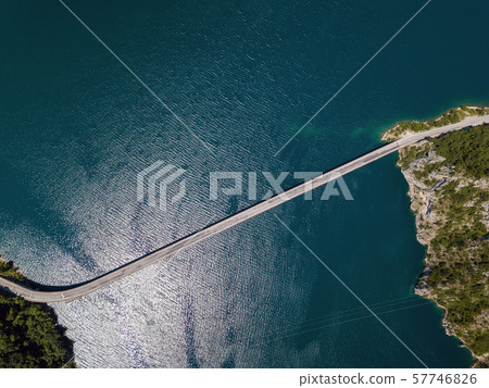 Aerial footage a car driving over a bridge on Piva Lake 57746826