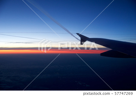 FRANKFURT, GERMANY - JAN 20th, 2017: View on the sunset, germany during winter and airplane wing FRANKFURT, GERMANY - JAN 20th, 2017: View on the sunset, germany during winter and airplane wing 57747269