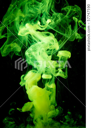 Green paint dissolves in water isolated on black background Green paint dissolves in water isolated on black background 57747590
