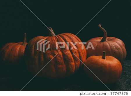 Photo of four orange pumpkins on black background, halloween celebration. Photo of four orange pumpkins on black background, halloween celebration. 57747876