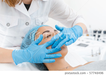 Beautician makes professional massage of the Beautician makes professional massage of the 57748496