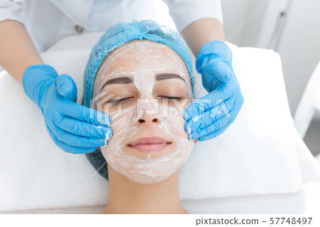 Close-up face of young girl relaxes and gets Close-up face of young girl relaxes and gets 57748497