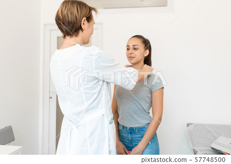 Therapist examines a young girl patient. Throat in Therapist examines a young girl patient. Throat in 57748500