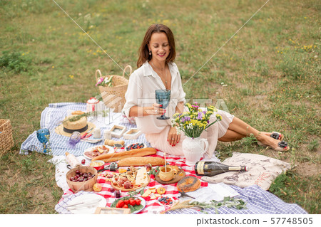Young brunette woman enjoy outdoor picnic on green 57748505