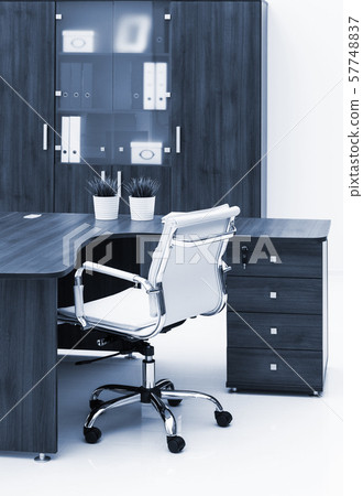 desk, chair and bookcase on white wall 57748837