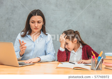 Mom and daughter on a gray background. During this, Mom found a solution to the problem on the 57748972