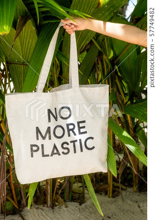 hand holding eco bag with sign No More plastic hand holding eco bag with sign No More plastic 57749482