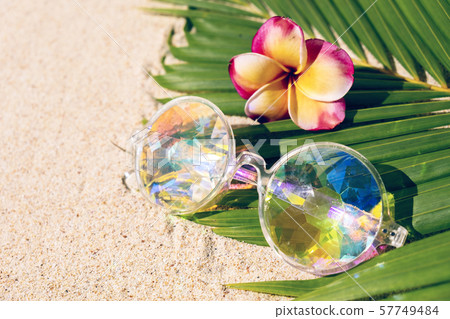 Funny kaleidoscope pink glasses on sand background Funny kaleidoscope pink glasses on sand background 57749484