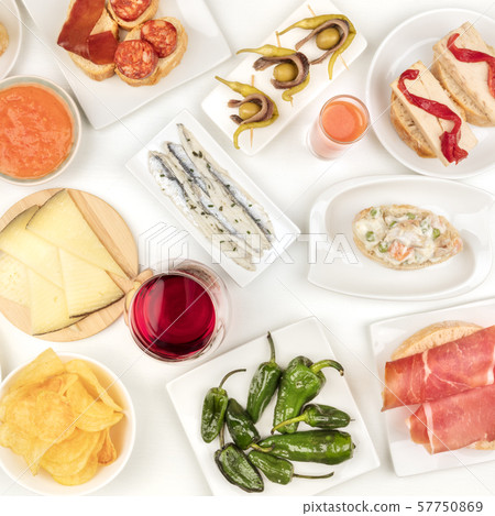 Spanish tapas, overhead square shot. Wine, sardines, Russian salad, padron peppers, jamon and other 57750869