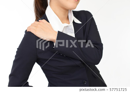 A woman suffering from stiff shoulders A woman suffering from stiff shoulders 57751725