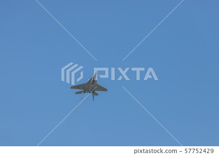 A military fighter jet flying in the sky upside down A military fighter jet flying in the sky upside down 57752429