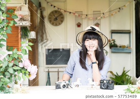 A Japanese woman who likes to take pictures is taking pictures. A Japanese woman who likes to take pictures is taking pictures. 57753489