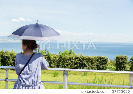 A woman staring at the sea 57755090