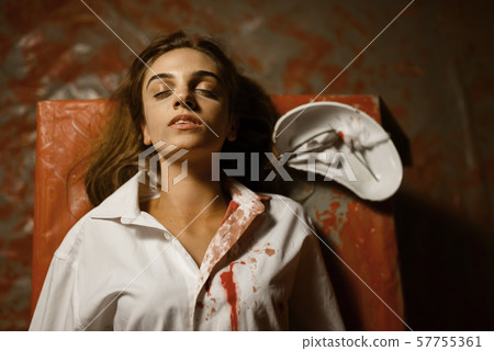 Victim of doctor maniac lying on surgical table 57755361