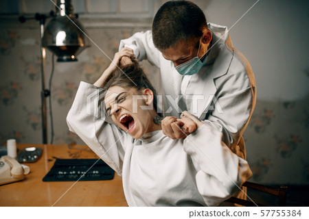 Psychiatrist with syringe makes sedative injection 57755384