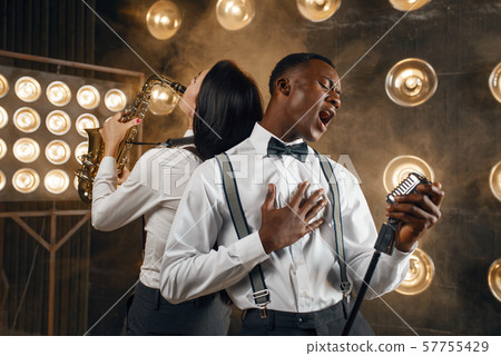 Male jazz performer and female saxophonist Male jazz performer and female saxophonist 57755429