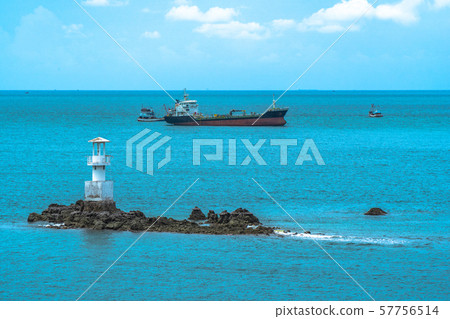 cargo boats moored near the lighthouse cargo boats moored near the lighthouse 57756514