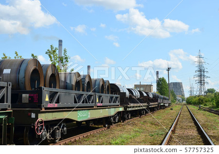 Steel sheets rolled up into rolls. Packing of steel for transportation freight train 57757325