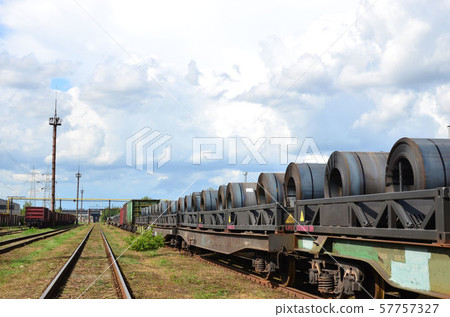 Steel sheets rolled up into rolls. Packing of steel for transportation freight train 57757327
