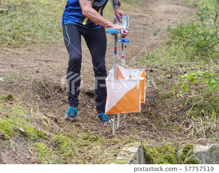 Running to an orienteering check point, put the Running to an orienteering check point, put the 57757519