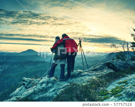 Nature photographers in red and light jacket take Nature photographers in red and light jacket take 57757528
