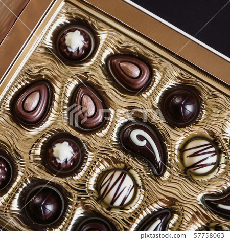 Chocolate candies of different shapes in a gold Chocolate candies of different shapes in a gold 57758063
