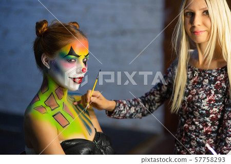 Makeup artis puts a aqua makeup on a alluring Makeup artis puts a aqua makeup on a alluring 57758293