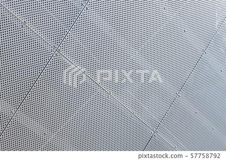 Close-up of white metal surface with a lot of tiny round openings Close-up of white metal surface with a lot of tiny round openings 57758792