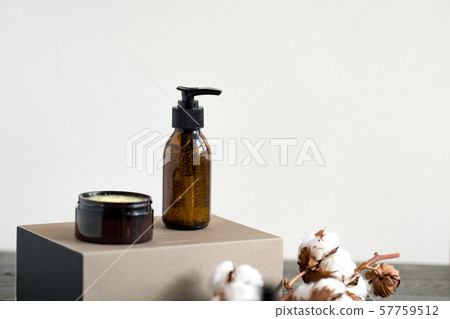 Brown glass cosmetic bottle and jar against white Brown glass cosmetic bottle and jar against white 57759512