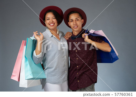 Young hispanic couple with shopping bags Young hispanic couple with shopping bags 57760361