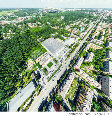 Aerial city view with crossroads and roads, houses, buildings, parks and parking lots. Sunny summer 57761103
