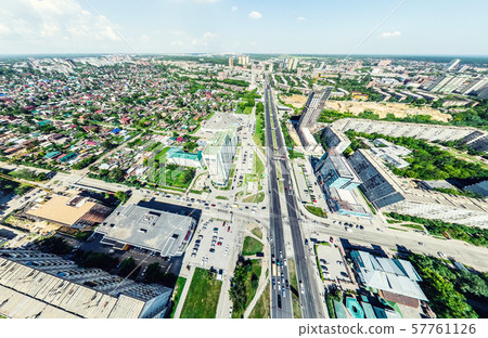Aerial city view with crossroads and roads, houses, buildings, parks and parking lots. Sunny summer Aerial city view with crossroads and roads, houses, buildings, parks and parking lots. Sunny summer 57761126