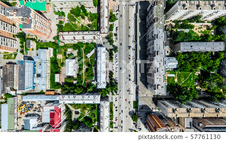 Aerial city view with crossroads and roads, houses, buildings, parks and parking lots. Sunny summer Aerial city view with crossroads and roads, houses, buildings, parks and parking lots. Sunny summer 57761130