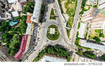 Aerial city view with crossroads and roads, houses, buildings, parks and parking lots. Sunny summer Aerial city view with crossroads and roads, houses, buildings, parks and parking lots. Sunny summer 57761132