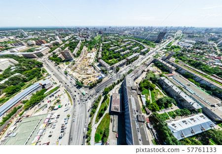 Aerial city view with crossroads and roads, houses, buildings, parks and parking lots. Sunny summer Aerial city view with crossroads and roads, houses, buildings, parks and parking lots. Sunny summer 57761133
